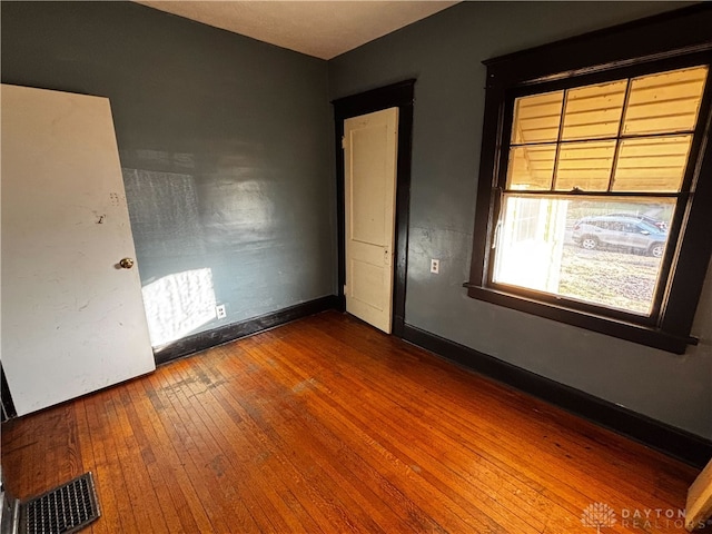 unfurnished bedroom featuring hardwood / wood-style flooring