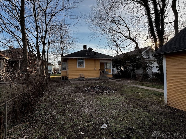 view of back house at dusk