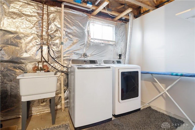 clothes washing area with sink and washer and clothes dryer