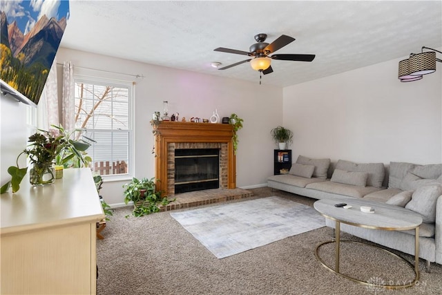 living room featuring a textured ceiling, a fireplace, ceiling fan, and carpet