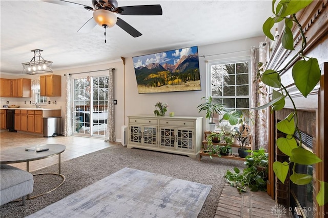 living room featuring light carpet, sink, crown molding, and a wealth of natural light