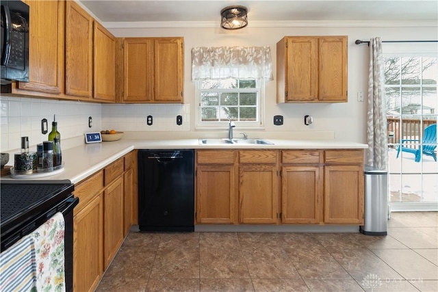 kitchen featuring tasteful backsplash, a wealth of natural light, sink, and black appliances