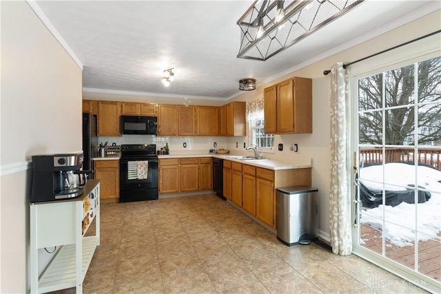 kitchen with crown molding, sink, and black appliances