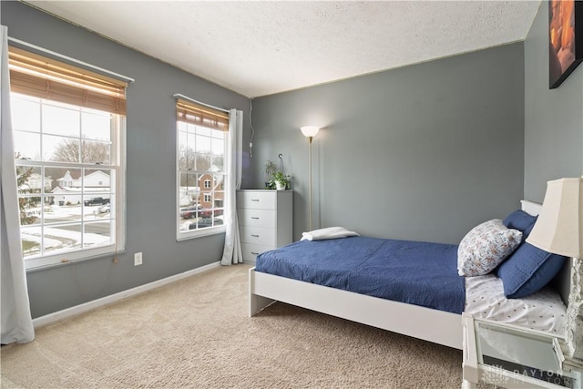 carpeted bedroom featuring a textured ceiling