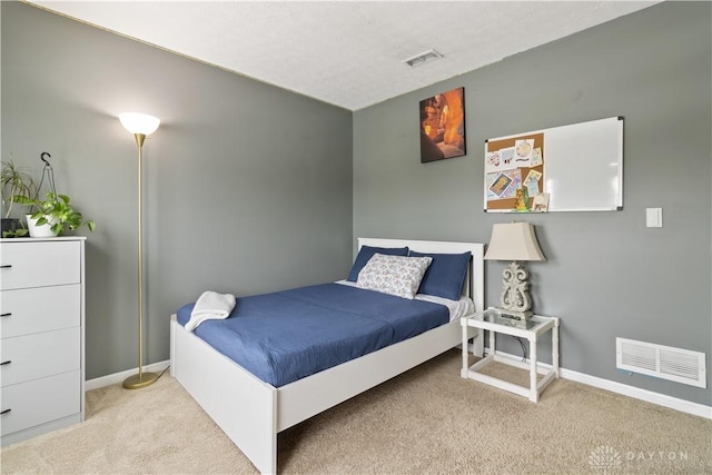 carpeted bedroom featuring a textured ceiling