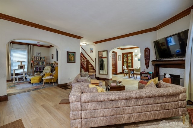 living room with crown molding and light hardwood / wood-style floors