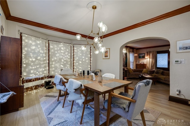 dining room featuring crown molding and light wood-type flooring