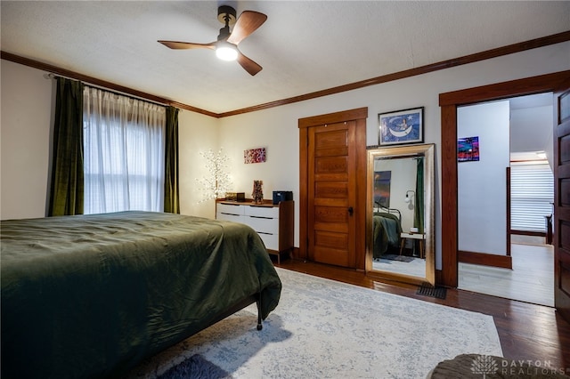 bedroom featuring crown molding, ceiling fan, and dark hardwood / wood-style flooring