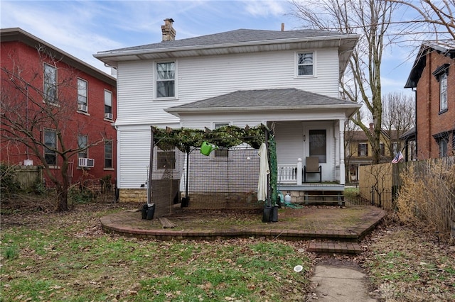 back of property with covered porch