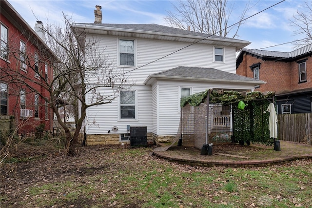 rear view of house featuring central AC unit