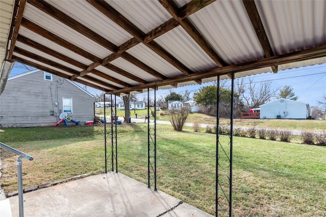 view of yard with a carport and a patio