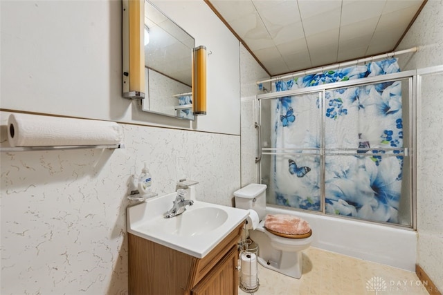 full bathroom featuring toilet, shower / bath combination with glass door, and vanity