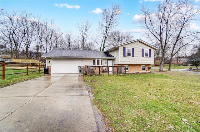 tri-level home with a garage, a deck, and a front lawn