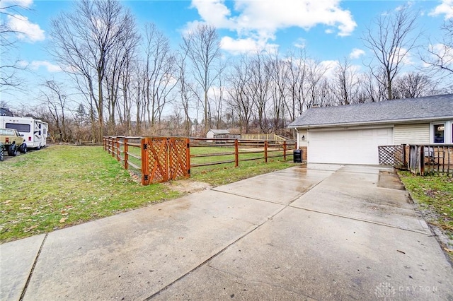 view of side of home featuring a garage and a lawn