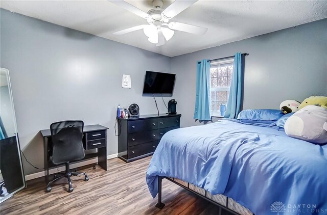 bedroom featuring wood-type flooring and ceiling fan