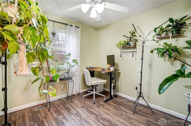 home office with hardwood / wood-style floors and ceiling fan