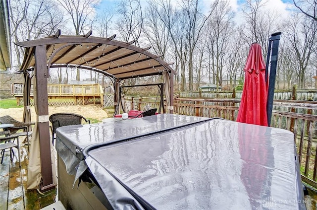 wooden terrace featuring a hot tub