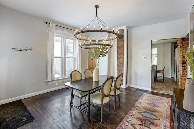 dining space with dark wood-type flooring and an inviting chandelier