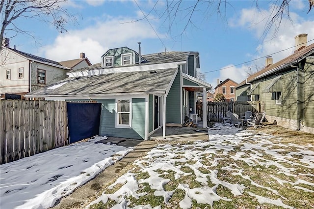 view of snow covered rear of property