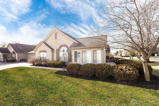 view of front of home with a garage and a front yard