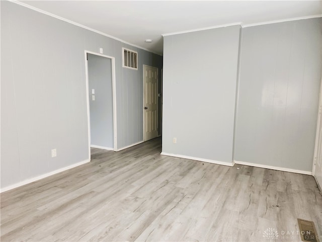 unfurnished room featuring crown molding and light hardwood / wood-style flooring