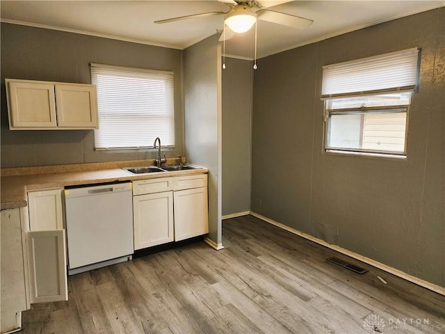 kitchen featuring crown molding, white dishwasher, sink, and light hardwood / wood-style flooring