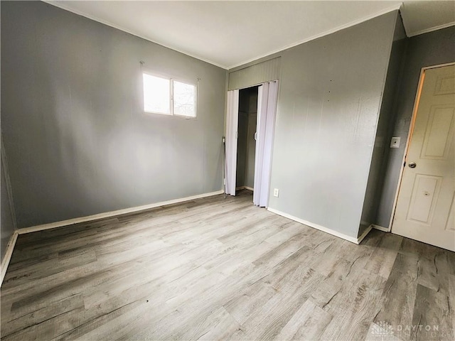 interior space with crown molding and light wood-type flooring