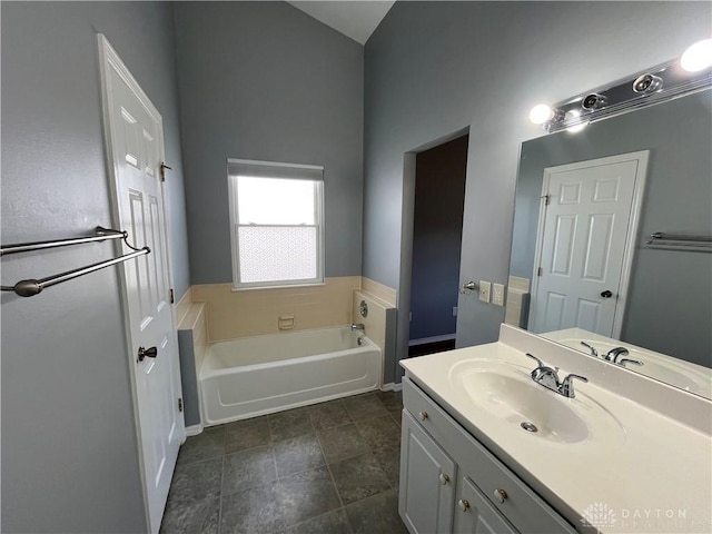 bathroom featuring vanity and a washtub