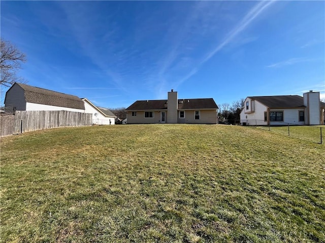 rear view of property with a yard