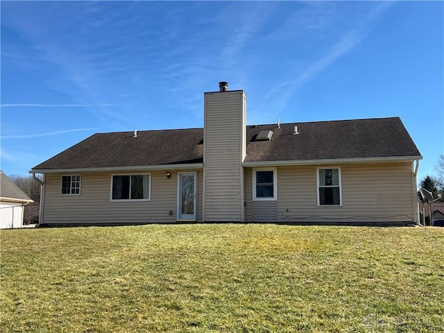 rear view of house with a lawn