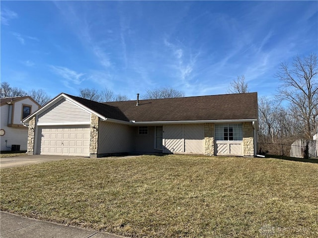 ranch-style home featuring cooling unit, a garage, and a front lawn