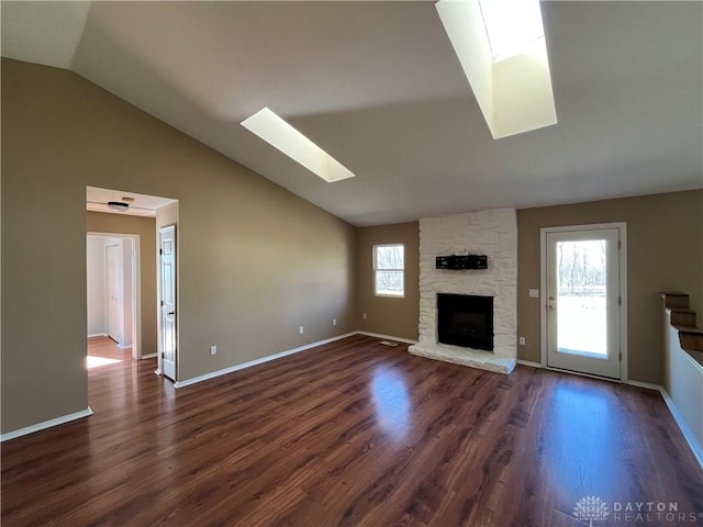 unfurnished living room with dark wood-type flooring, a wealth of natural light, and a fireplace