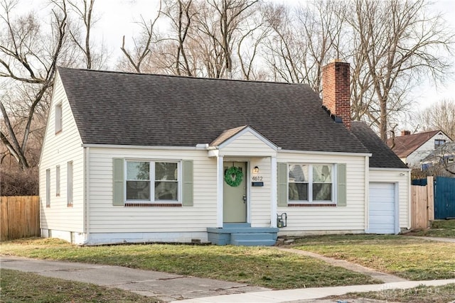 view of front of property with a garage and a front lawn