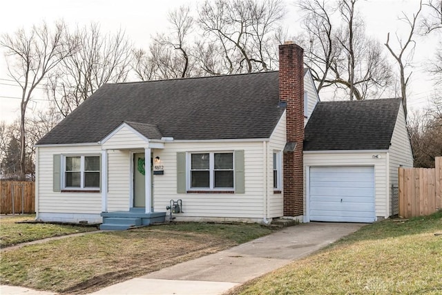 cape cod house featuring a garage and a front lawn