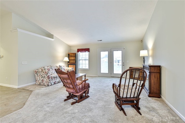 living area featuring vaulted ceiling and light carpet