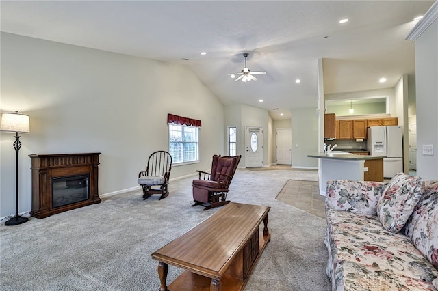 carpeted living room with high vaulted ceiling and ceiling fan