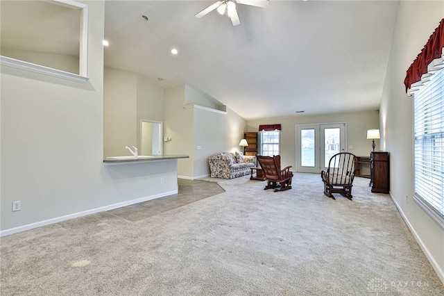 living room featuring light carpet, high vaulted ceiling, and ceiling fan