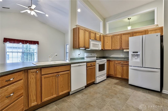 kitchen featuring lofted ceiling, sink, white appliances, ceiling fan, and hanging light fixtures