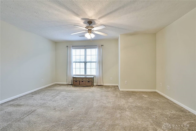 carpeted empty room with a textured ceiling and ceiling fan