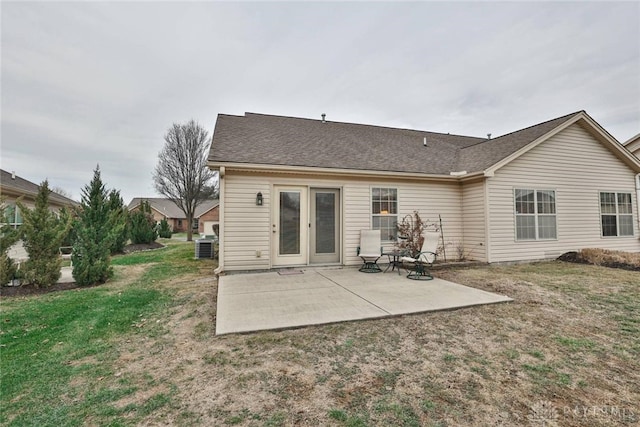 back of property with a patio area and a lawn