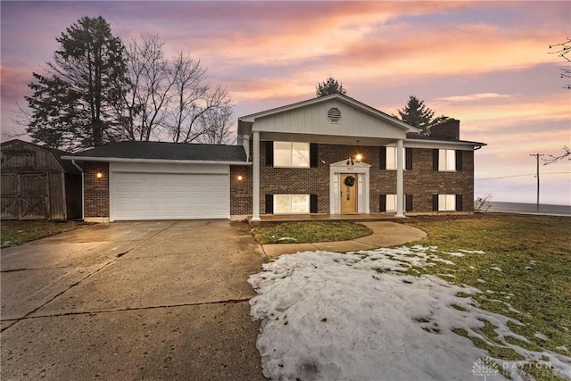 view of front of home featuring a garage and a yard