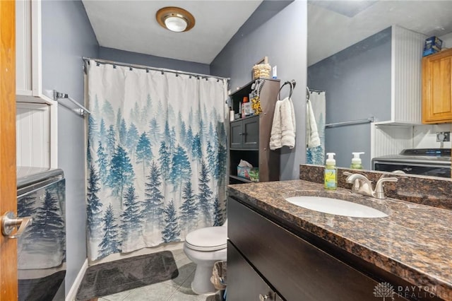 bathroom with tile patterned flooring, vanity, and toilet