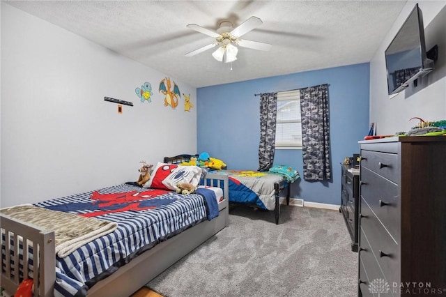 bedroom with ceiling fan, light carpet, and a textured ceiling