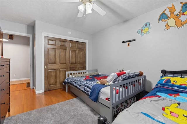 bedroom featuring ceiling fan and light hardwood / wood-style flooring