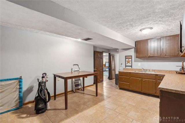 kitchen featuring sink and a textured ceiling