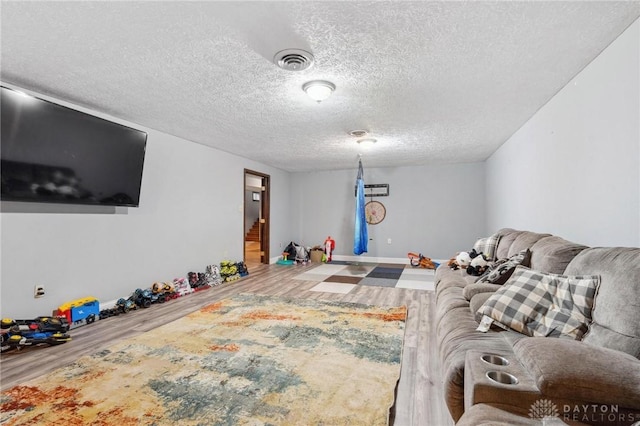 living room with hardwood / wood-style floors and a textured ceiling