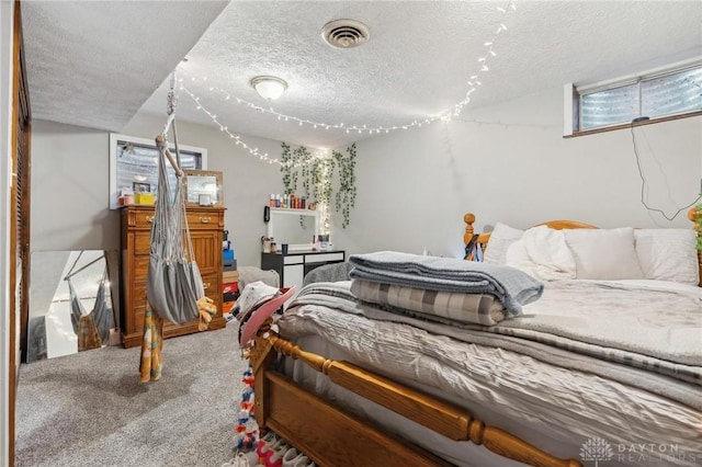 bedroom featuring carpet flooring and a textured ceiling