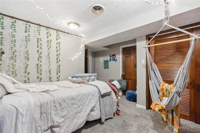 carpeted bedroom featuring a textured ceiling