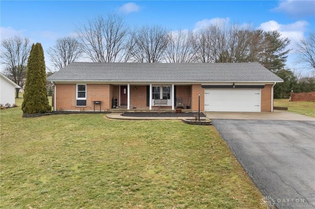 single story home with a garage and a front lawn