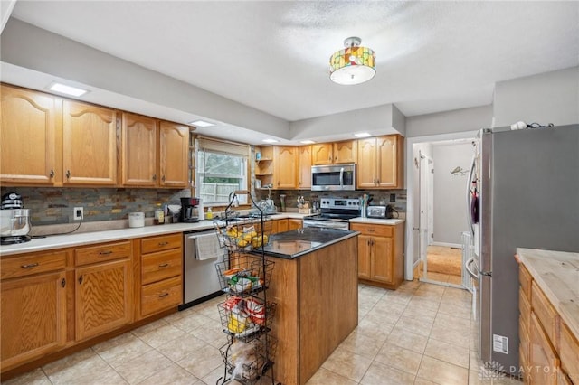 kitchen featuring a kitchen island, sink, decorative backsplash, light tile patterned floors, and stainless steel appliances